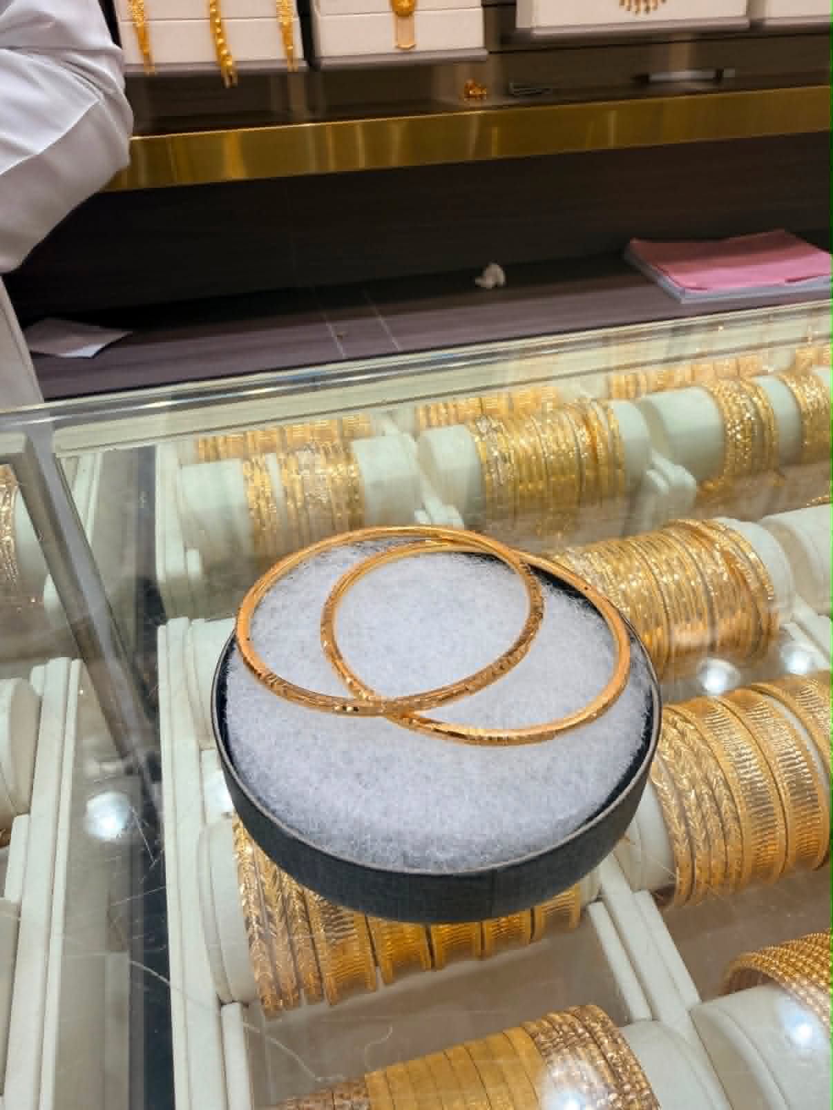 Gold bangles displayed with a wider bangle selection