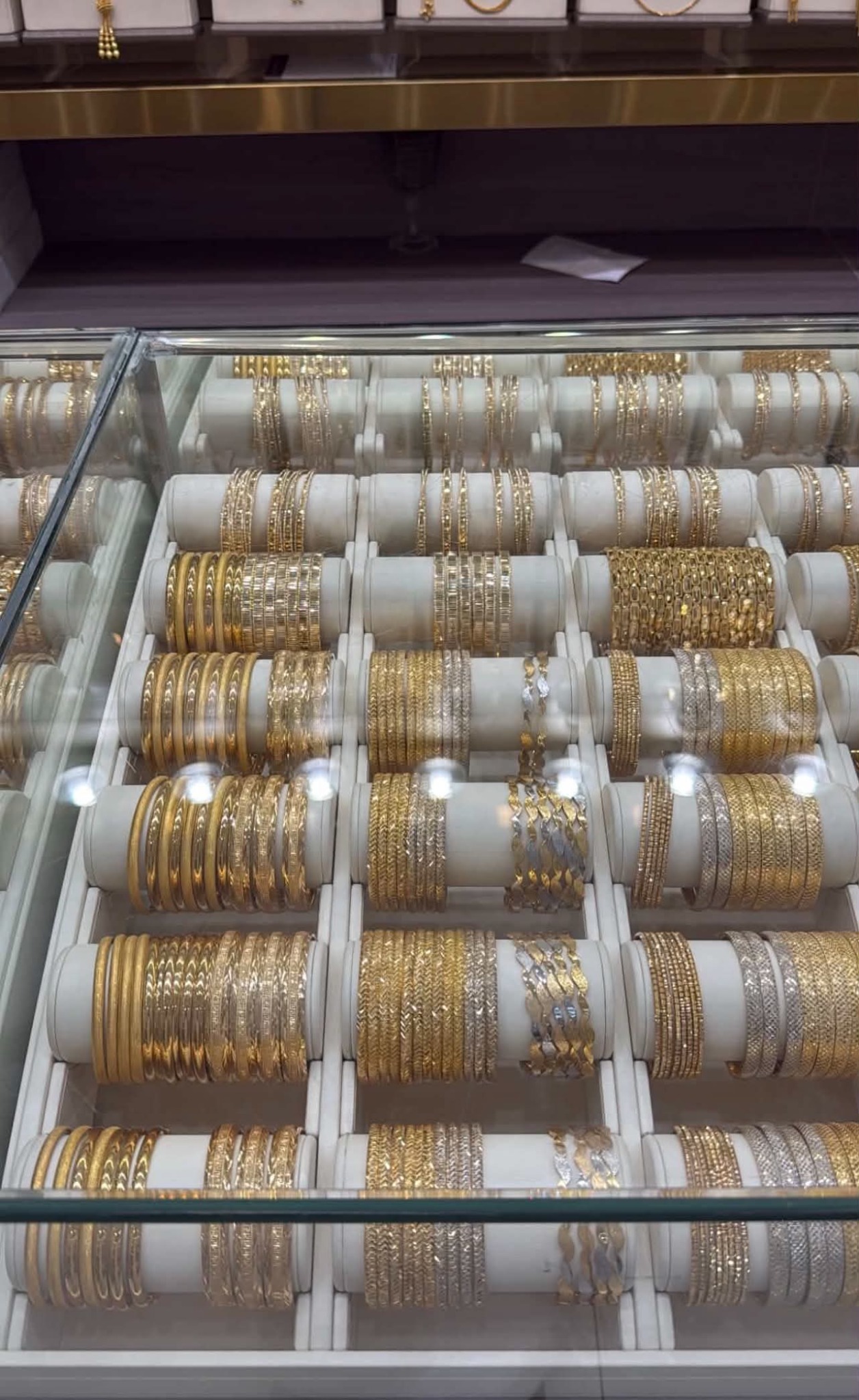 Gold bangle styles arranged in a display case